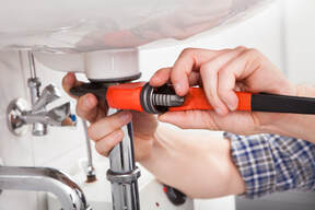 goodyear plumbing fixing a leak underneath a sink