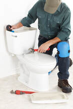 Professional plumber fixing a toilet in Goodyear, Arizona