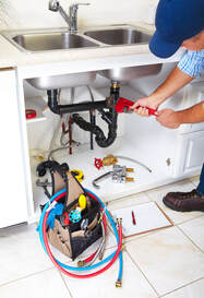 commercial plumber fixing a sink in goodyear 